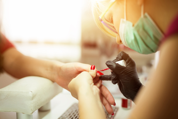 Manicure with red nail polish Stock Photo