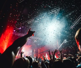 Night party festival crowd of people silhouettes hands up