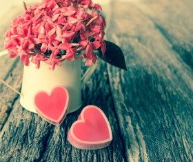Pink flowers and pink heart-shaped on the table Stock Photo