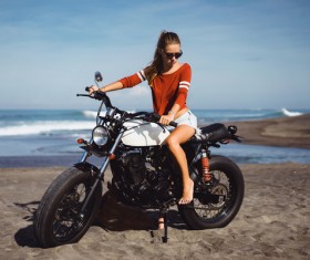 Pretty hipster girl riding a motorcycle Stock Photo