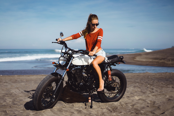 Pretty hipster girl riding a motorcycle Stock Photo