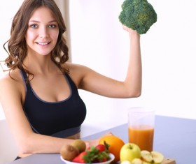 Sitting on the table holding cauliflower beautiful young women