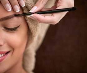Smiling female tattoo of beauty make-up