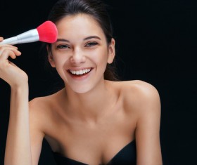 Smiling woman with foundation brush