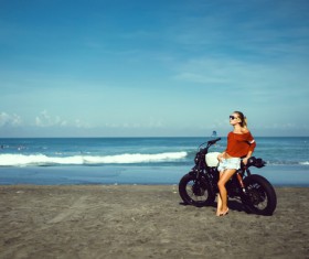 Stock Photo Pretty hipster girl Biker on the beach