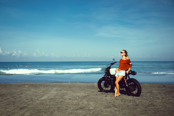 Stock Photo Pretty hipster girl Biker on the beach