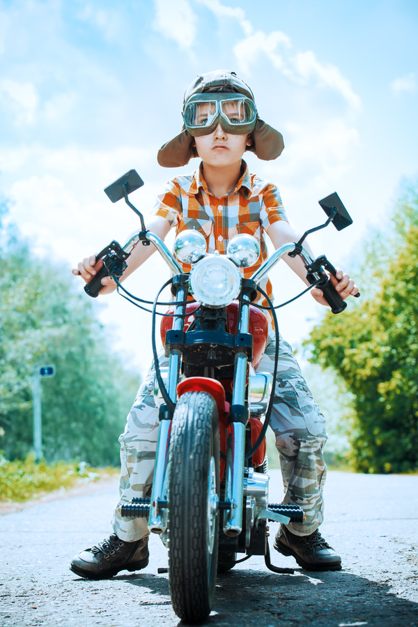Sunny day riding a motorcycle boy Stock Photo