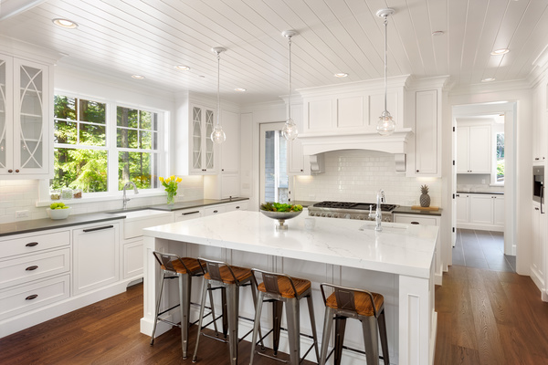 The bright, spacious white chandelier ceiling kitchen and center island