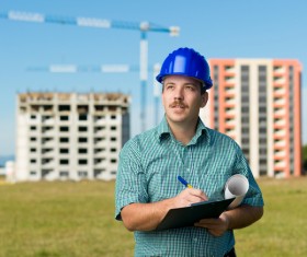 The building engineer is recording the background of the crane with the building 01