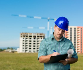 The building engineer is recording the background of the crane with the building 02