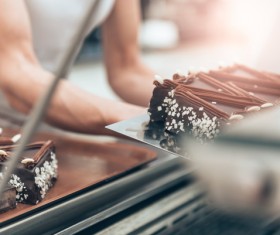 The cake maker who is making the chocolate cake