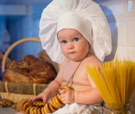 The cook costume Baby holding cookies Stock Photo