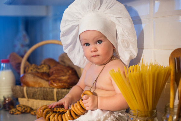 The cook costume Baby holding cookies Stock Photo