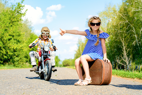 The fashionable girl asked to ride with a boy riding a motorcycle Stock Photo