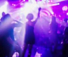 The girl with T and music dancing with the fuzzy purple background