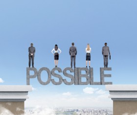 The men and women standing on the letters