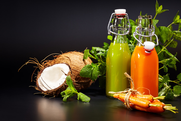 Vegetable juice with open coconut Stock Photo