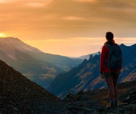 Watching the sunset woman on the hilltop Stock Photo