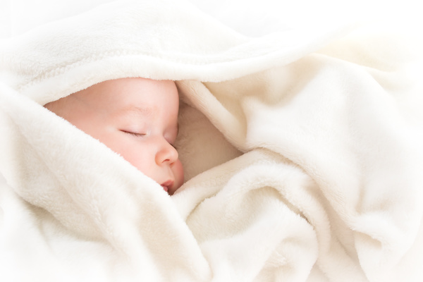 White blanket wrapped in newborn baby Stock Photo