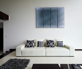 White minimalist living room with white couch with black cushion