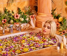 Women relaxing spa water bath petals Stock Photo