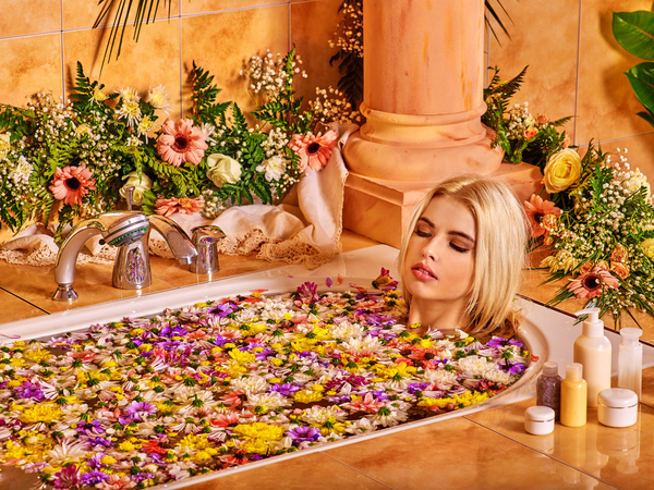 Women relaxing spa water bath petals Stock Photo