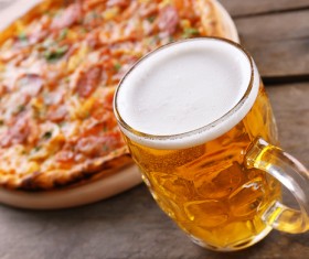 Wooden pizza on the table with beer Stock Photo