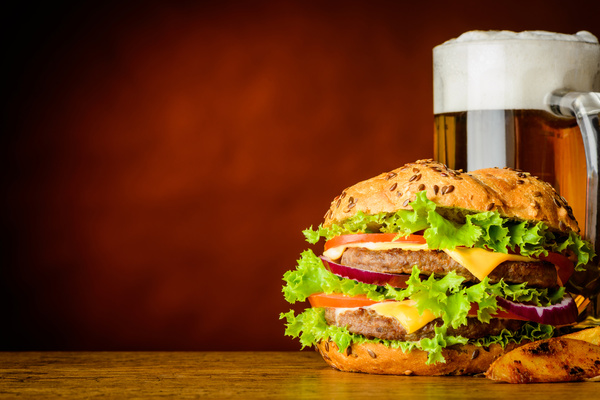 Wooden table top with hamburgers and beer Stock Photo