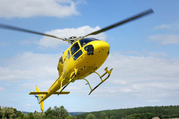Yellow helicopter flying under blue sky Stock Photo 02