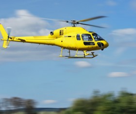 Yellow helicopter flying under blue sky Stock Photo 04