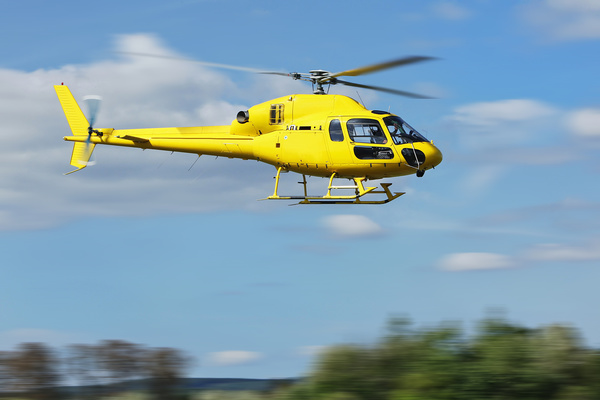 Yellow helicopter flying under blue sky Stock Photo 04