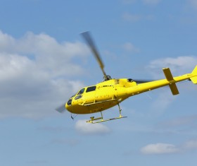 Yellow helicopter flying under blue sky Stock Photo 05