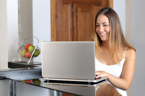 Young beautiful woman typing on her laptop to chat Stock Photo