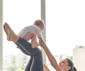 Young mom and baby together with exercise Stock Photo
