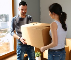 A couple carrying boxes Stock Photo