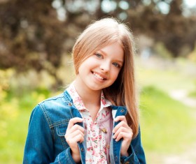 A pretty blonde girl in a denim jacket