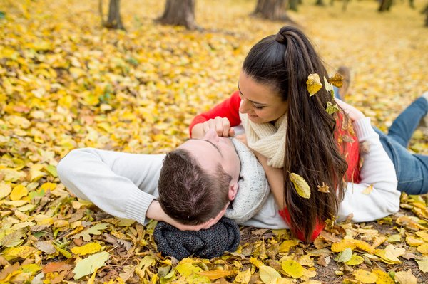 Autumn in the park Sweet young couple Stock Photo