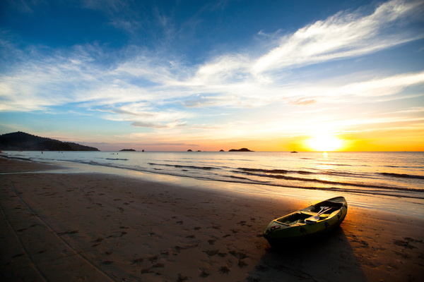 Beautiful sunset with beach boat Stock Photo