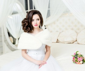 Beautiful wedding bride sitting on the bedside luxury Stock Photo 01