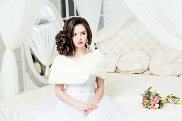 Beautiful wedding bride sitting on the bedside luxury Stock Photo 01