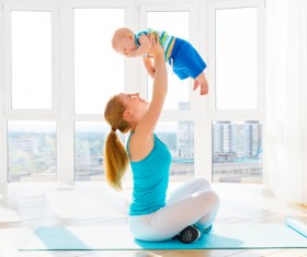 Bright living room Young mother holding a baby Stock Photo