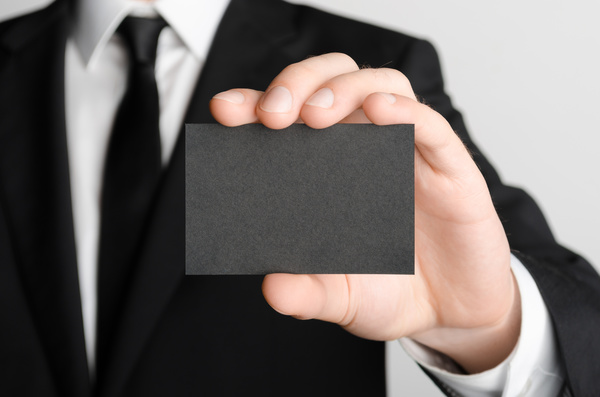 Business people with black business cards Stock Photo