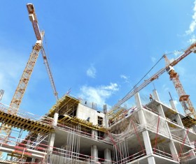 Capped buildings and cranes Stock Photo