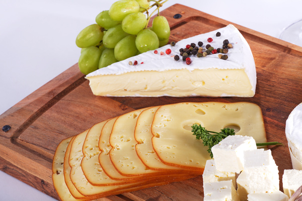 Cheese with grapes on the plate Stock Photo