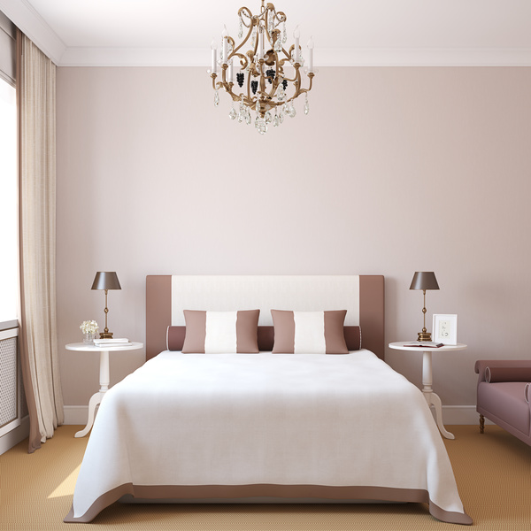 Comfortable bedroom with chandelier Stock Photo
