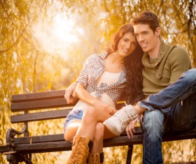 Couple sitting in park bench resting HD picture