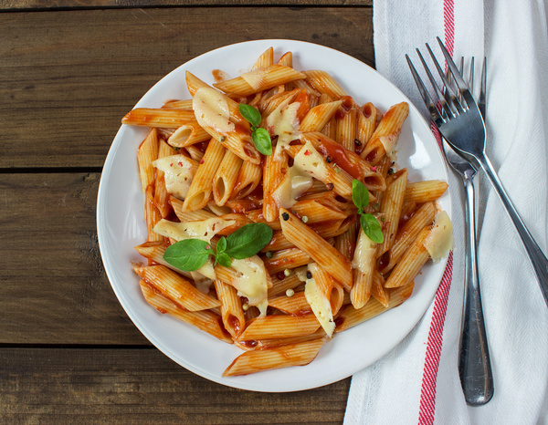Delicious Italian pasta and tablecloth Stock Photo