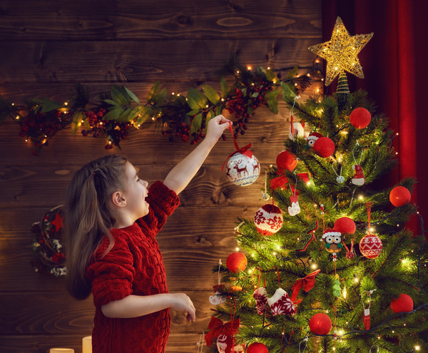Girl decorating christmas tree Stock Photo