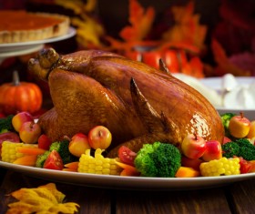 Golden roast turkey with corn fruit and vegetable decoration Stock Photo