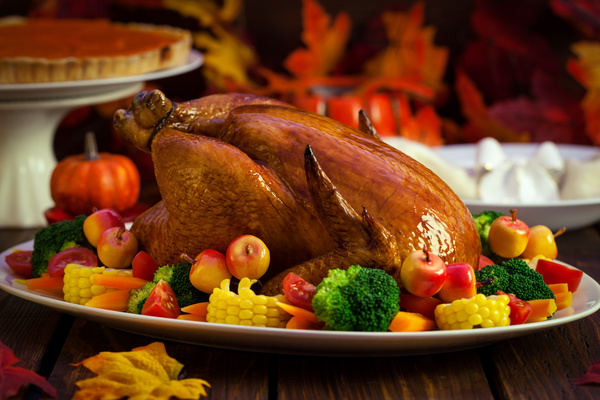 Golden roast turkey with corn fruit and vegetable decoration Stock Photo